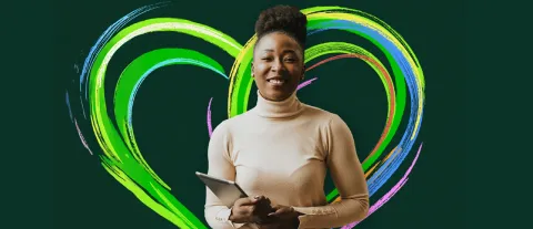 Dipendente Benifex con un tablet davanti a un cuore dipinto, dal report annuale sui benefit